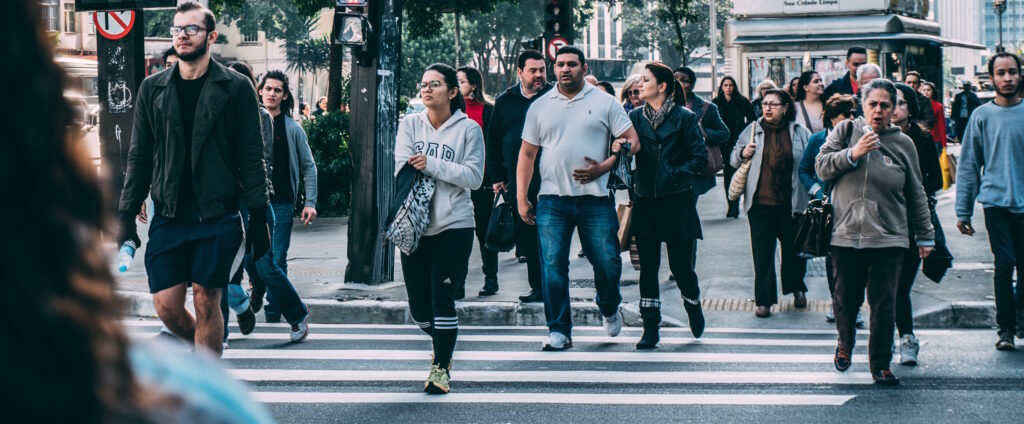 pedestrians walking across the street in a crosswalk